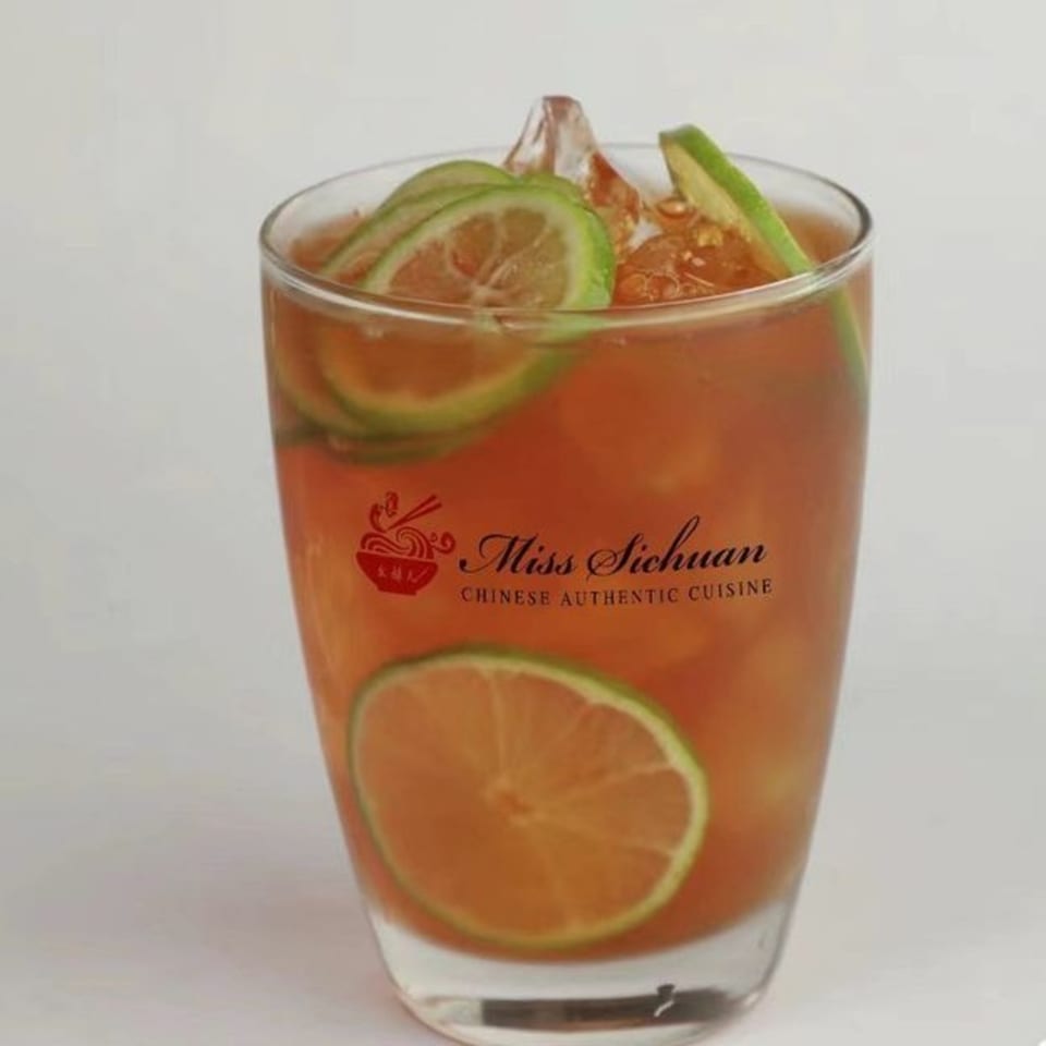 A glass of iced tea with lime slices and the Miss Sichuan logo on a white background.